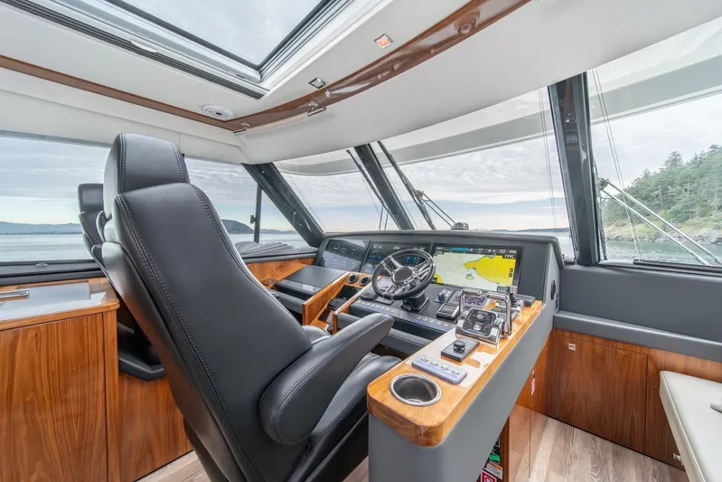  Yacht Photos Pics Luxurious helm of 2021 Riviera 64 Sports Motor Yacht with advanced navigation system.