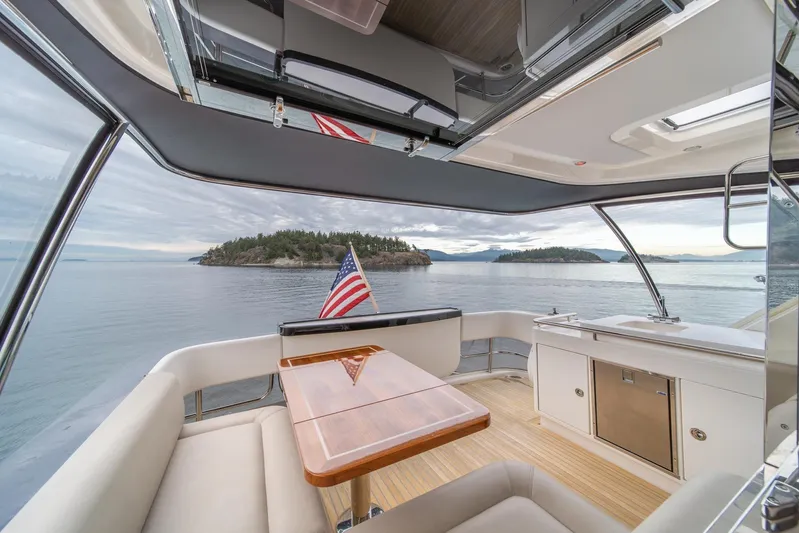  Yacht Photos Pics Interior view of 2021 Riviera 64 Sports Motor Yacht with scenic ocean backdrop.