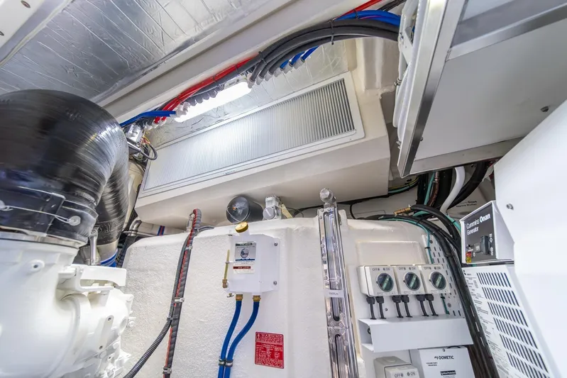  Yacht Photos Pics Engine room of 2021 Riviera 64 Sports Motor Yacht with visible wiring and equipment.