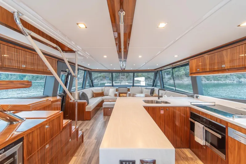  Yacht Photos Pics Luxurious interior of 2021 Riviera 64 Sports Motor Yacht with modern wood finishes.