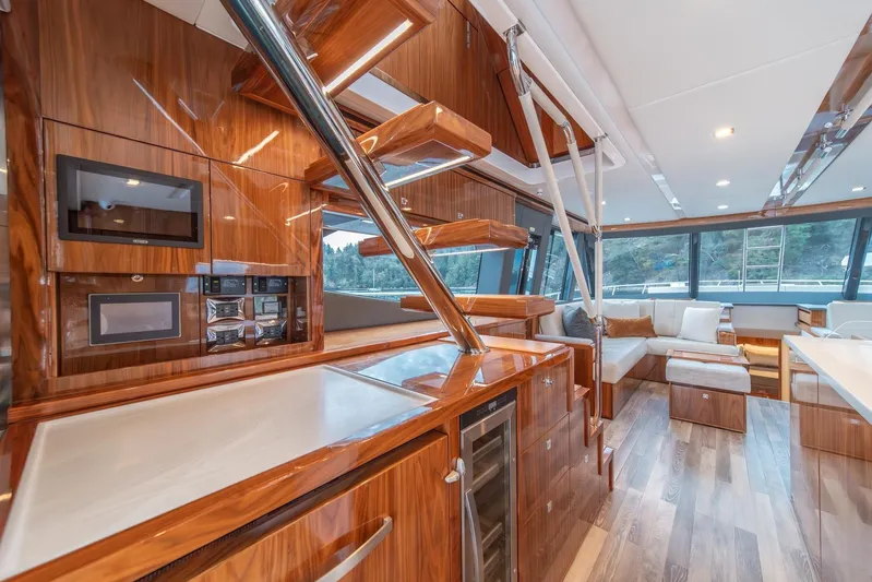  Yacht Photos Pics Luxurious interior of 2021 Riviera 64 Sports Motor Yacht with modern kitchen and seating area.