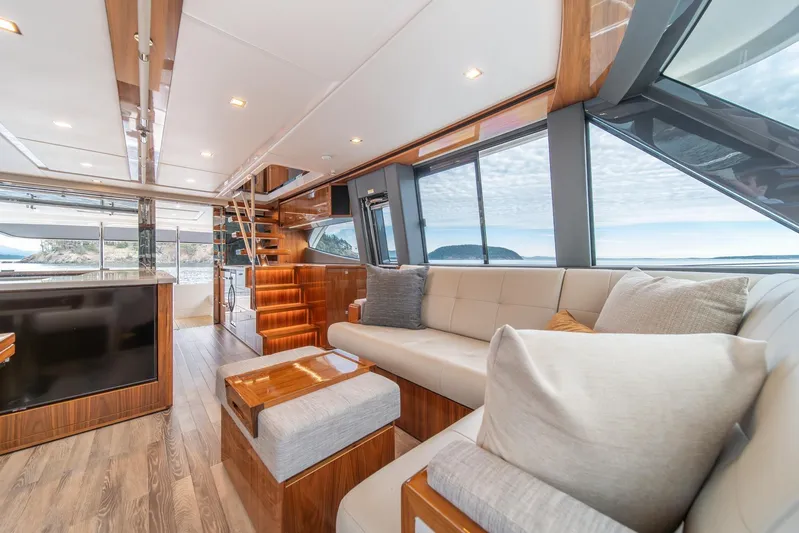  Yacht Photos Pics Luxurious interior of 2021 Riviera 64 Sports Motor Yacht with elegant seating and panoramic windows.