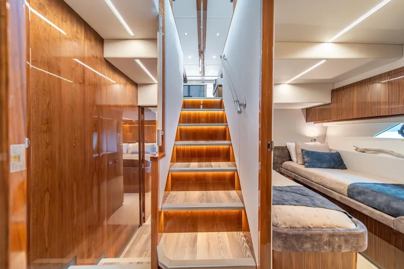  Yacht Photos Pics Luxurious interior of 2021 Riviera 64 Sports Motor Yacht with elegant wood finishes and cozy seating.