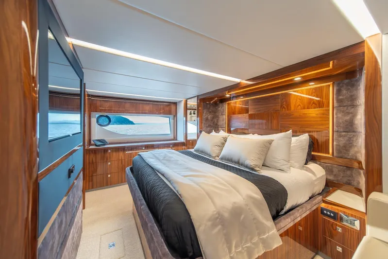  Yacht Photos Pics Luxurious bedroom interior of 2021 Riviera 64 Sports Motor Yacht with ocean view.