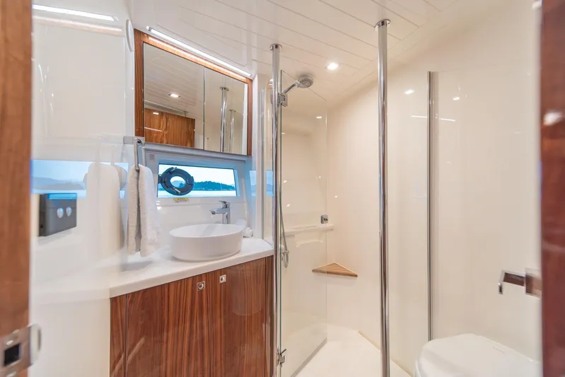  Yacht Photos Pics Luxurious bathroom in 2021 Riviera 64 Sports Motor Yacht with modern fixtures and elegant design.