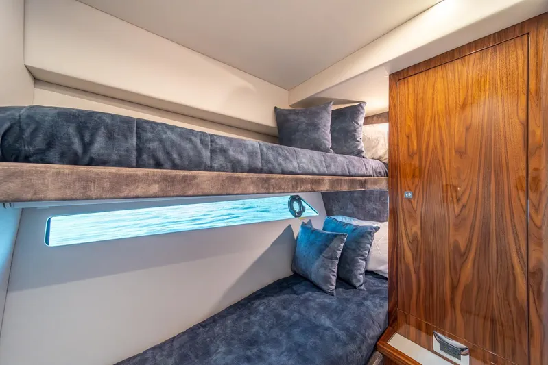  Yacht Photos Pics Luxurious cabin interior of 2021 Riviera 64 Sports Motor Yacht with bunk beds.