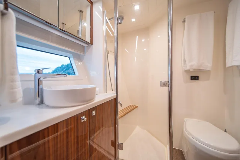  Yacht Photos Pics Luxurious bathroom in 2021 Riviera 64 Sports Motor Yacht with modern fixtures and elegant design.