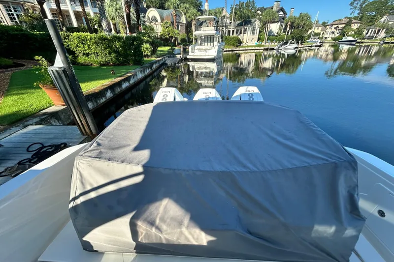  Yacht Photos Pics 2023 Tiara Yachts 38 LS docked, covered, with scenic waterfront view.