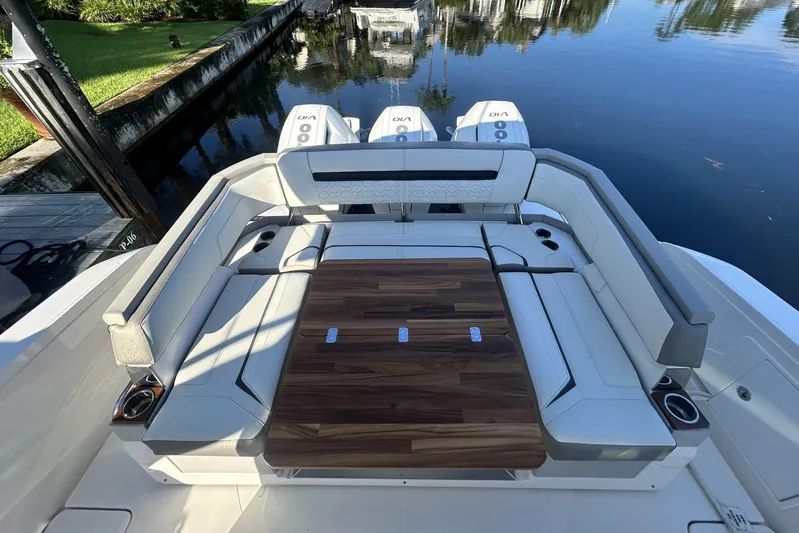  Yacht Photos Pics 2023 Tiara Yachts 38 LS luxury seating area with wooden table and cup holders.