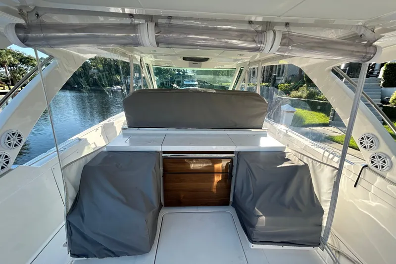  Yacht Photos Pics 2023 Tiara Yachts 38 LS interior with covered seating and sleek design.