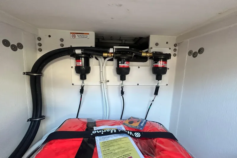  Yacht Photos Pics Engine compartment of 2023 Tiara Yachts 38 LS with fuel filters and safety equipment.