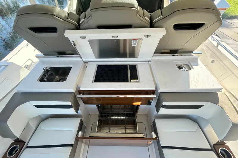  Yacht Photos Pics 2023 Tiara Yachts 38 LS boat interior with sink, grill, and seating area.