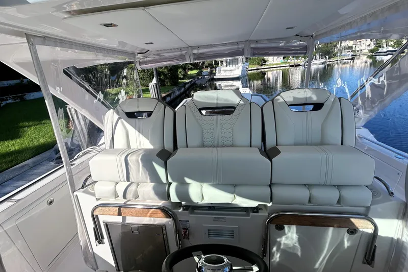 Yacht Photos Pics 2023 Tiara Yachts 38 LS interior with luxurious seating and scenic waterfront view.