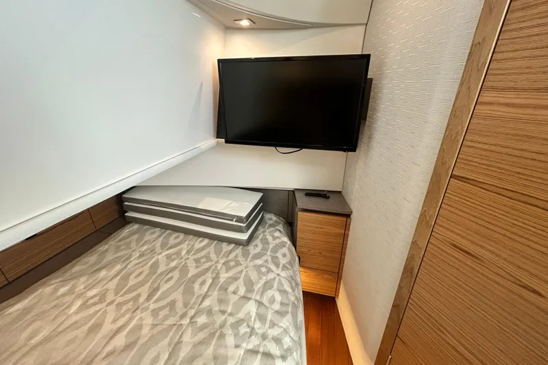  Yacht Photos Pics 2023 Tiara Yachts 38 LS cabin interior with TV and modern wood accents.