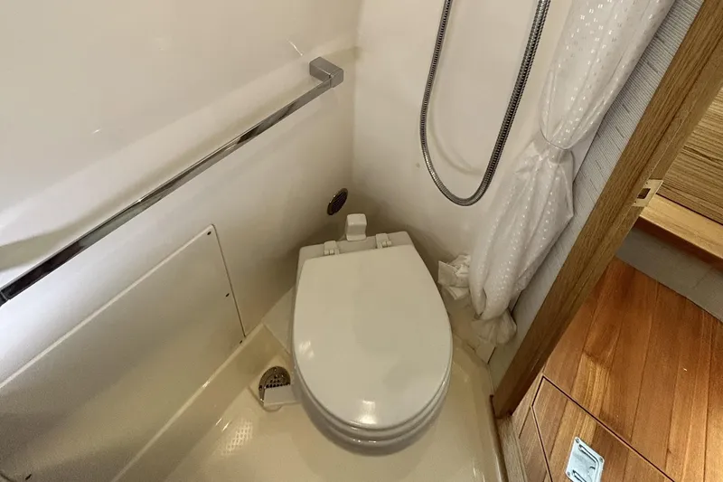  Yacht Photos Pics 2023 Tiara Yachts 38 LS bathroom with toilet and shower area.