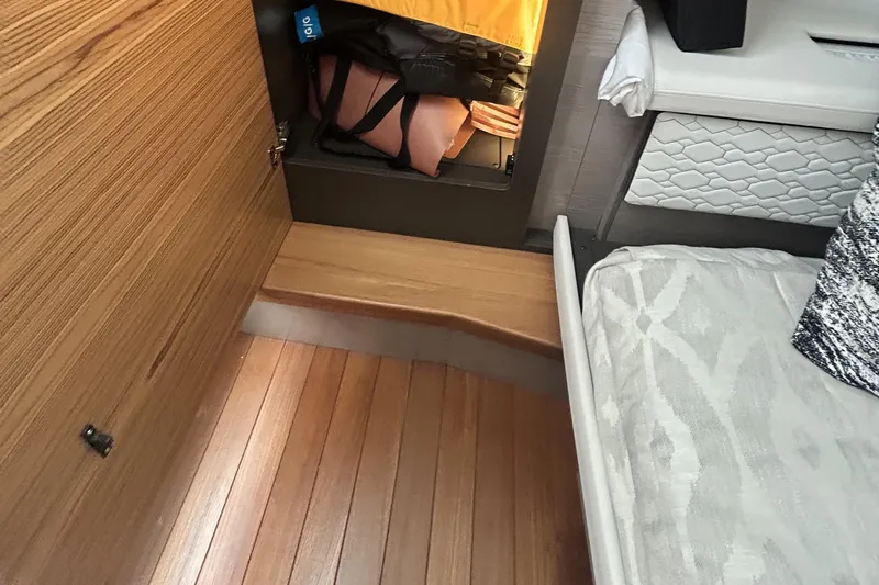  Yacht Photos Pics 2023 Tiara Yachts 38 LS interior with wooden flooring and storage compartment.