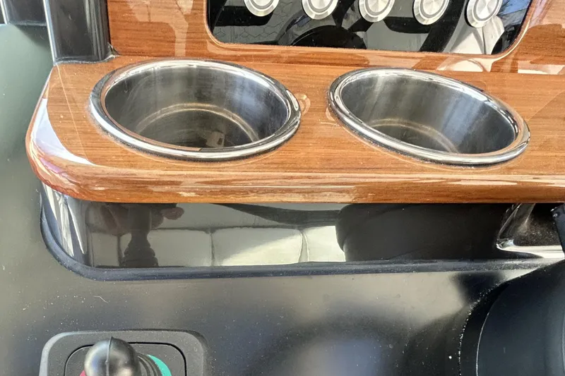  Yacht Photos Pics 2023 Tiara Yachts 38 LS dashboard with dual cup holders and control panel.