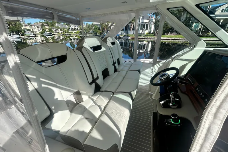  Yacht Photos Pics 2023 Tiara Yachts 38 LS interior with luxurious seating and modern helm controls.