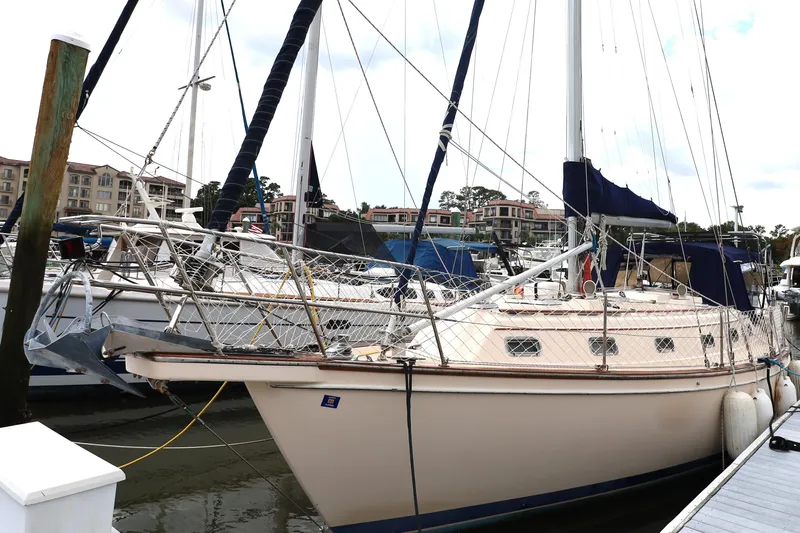 Carpe Diem Yacht Photos Pics 1995 Island Packet 40 sailboat docked at marina, surrounded by other boats.