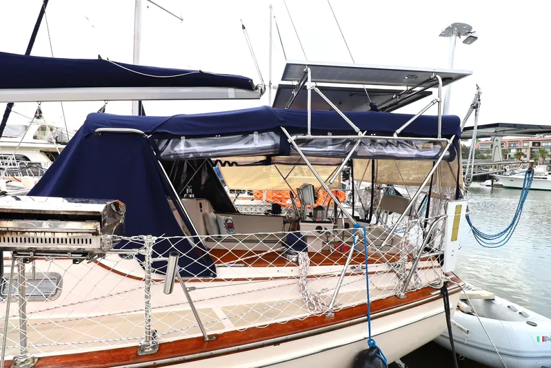 Carpe Diem Yacht Photos Pics 1995 Island Packet 40 sailboat docked, featuring blue canopy and solar panels.