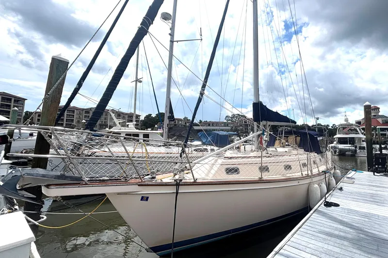 Carpe Diem Yacht Photos Pics 1995 Island Packet 40 sailboat docked at a marina under cloudy skies.