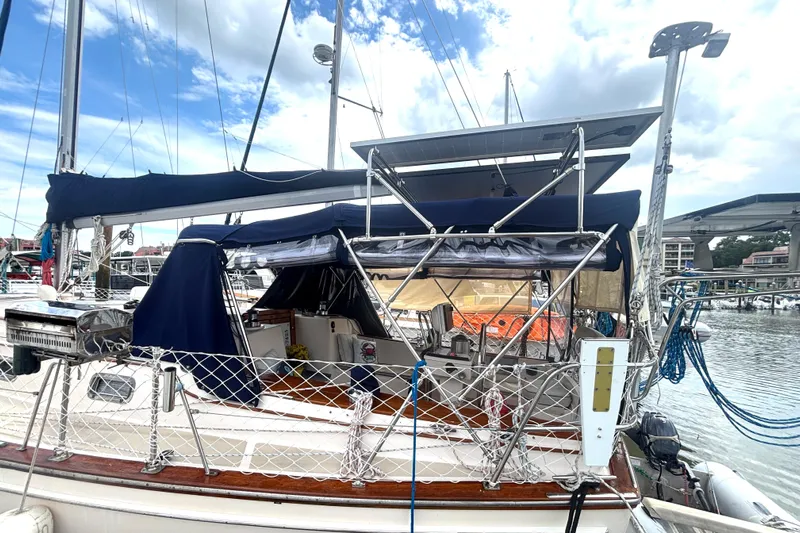 Carpe Diem Yacht Photos Pics Sailboat Island Packet 40, 1995 model, docked with solar panels and blue canopy.
