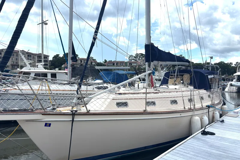 Carpe Diem Yacht Photos Pics 1995 Island Packet 40 sailboat docked at marina under cloudy sky.