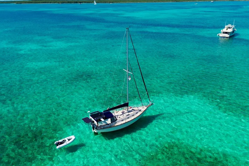 Carpe Diem Yacht Photos Pics Island Packet 40 sailboat anchored in clear turquoise waters, 1995 model.