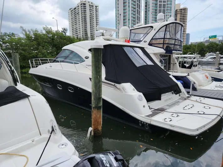 Moonwake Yacht Photos Pics 2014 Sea Ray 470 Sundancer yacht docked in marina with cityscape background.