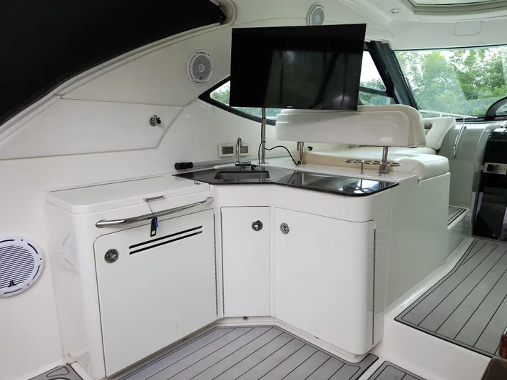 Moonwake Yacht Photos Pics Interior of 2014 Sea Ray 470 Sundancer yacht with sleek cabinetry and mounted TV.