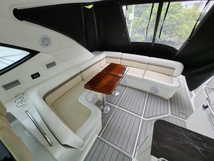 Moonwake Yacht Photos Pics Luxurious interior of 2014 Sea Ray 470 Sundancer yacht with elegant seating and wooden table.