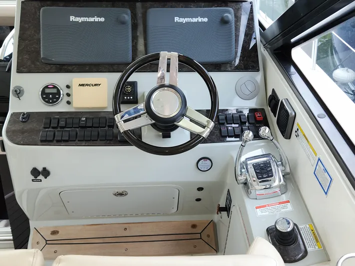 Moonwake Yacht Photos Pics Helm of 2014 Sea Ray 470 Sundancer with Raymarine displays and Mercury controls.