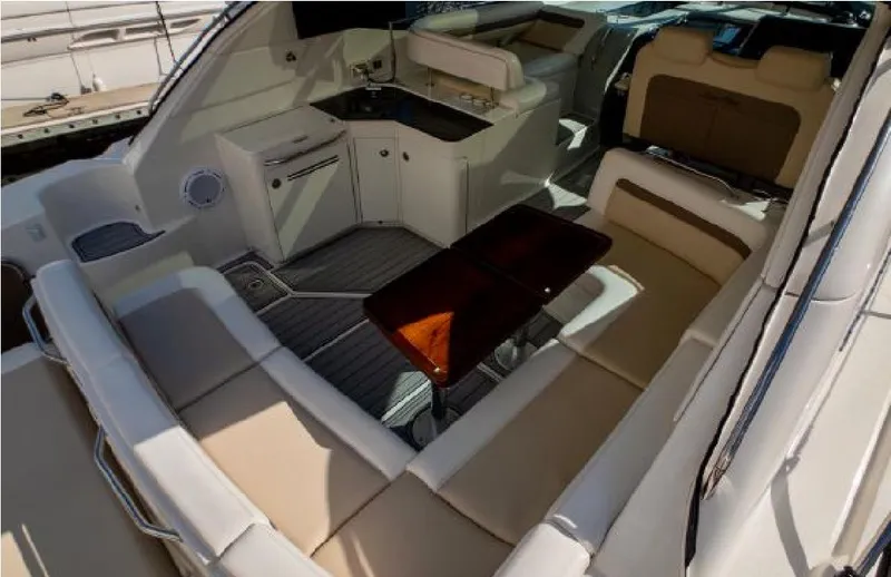 Moonwake Yacht Photos Pics Luxurious interior of 2014 Sea Ray 470 Sundancer yacht with seating and kitchenette.