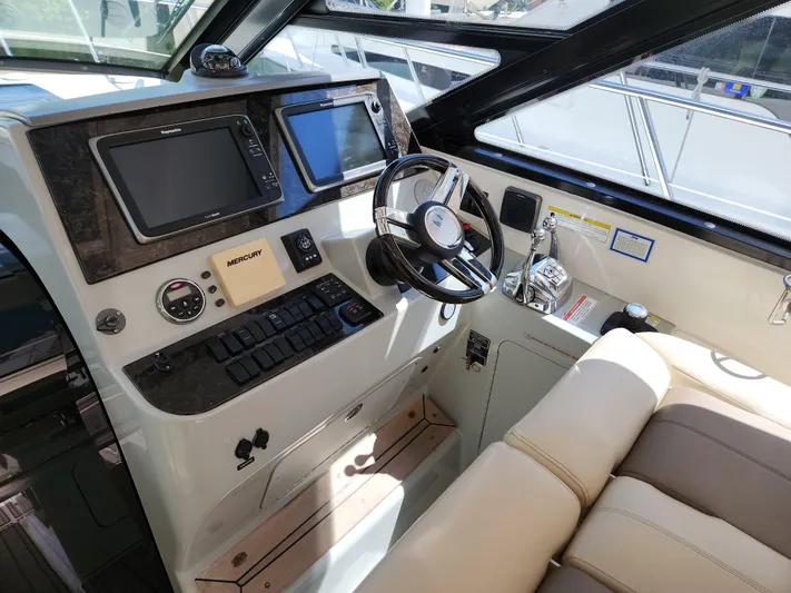 Moonwake Yacht Photos Pics 2014 Sea Ray 470 Sundancer helm with modern controls and navigation screens.