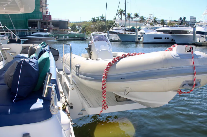 Tiger Lily Yacht Photos Pics Lagoon 620 catamaran with inflatable dinghy docked at marina, 2015 model.