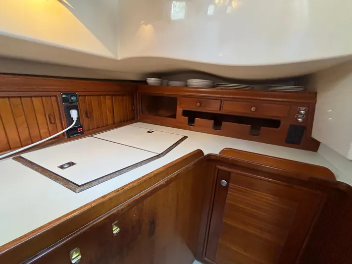 Carpe Diem Yacht Photos Pics Interior of 1995 Island Packet 40 sailboat galley with wooden cabinetry and countertop.