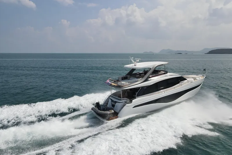 La Mer Yacht Photos Pics 2023 Princess Y72 yacht cruising on open sea under clear skies.