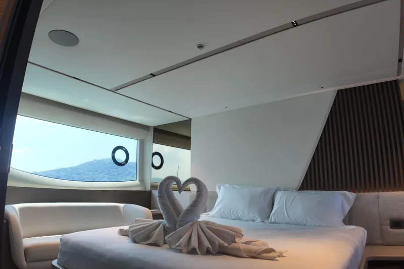 La Mer Yacht Photos Pics Luxurious bedroom interior on 2023 Princess Y72 yacht with elegant decor and scenic window view.