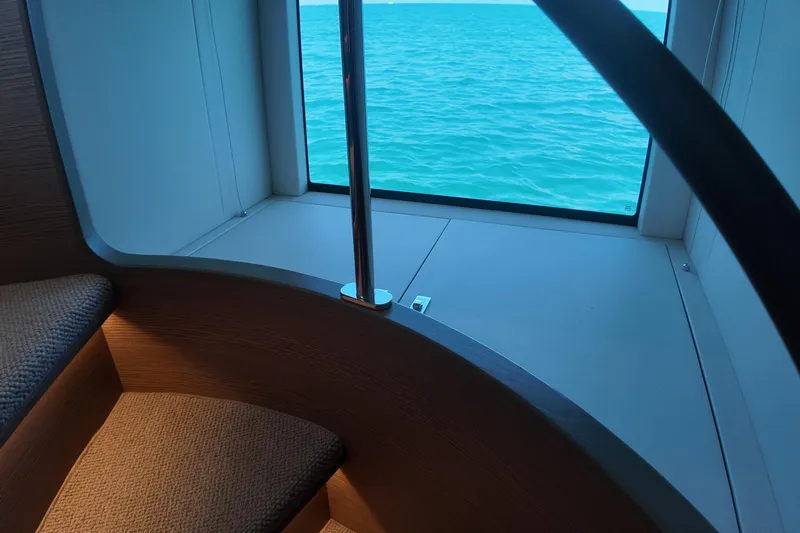 La Mer Yacht Photos Pics Interior view of 2023 Princess Y72 yacht with ocean through window.