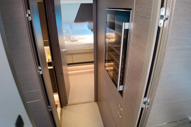 La Mer Yacht Photos Pics Luxurious interior of 2023 Princess Y72 yacht, featuring elegant bedroom and modern cabinetry.