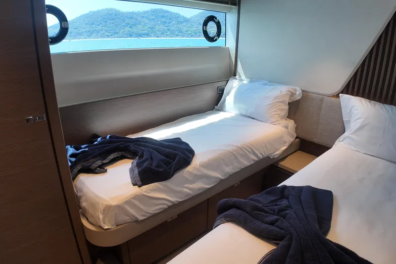 La Mer Yacht Photos Pics Luxurious cabin interior of 2023 Princess Y72 yacht with twin beds and scenic window view.