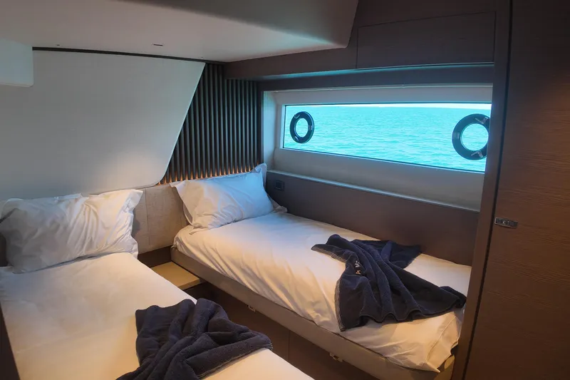La Mer Yacht Photos Pics Luxurious cabin interior of 2023 Princess Y72 yacht with twin beds and ocean view.