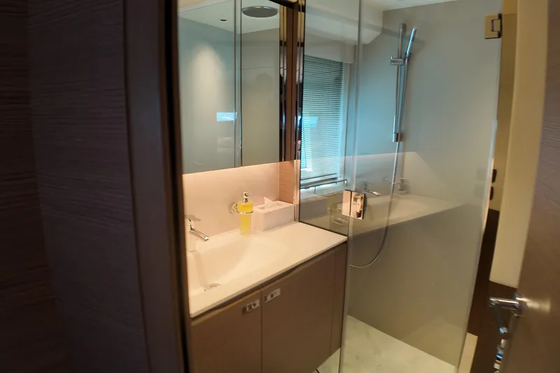 La Mer Yacht Photos Pics Luxurious bathroom in 2023 Princess Y72 yacht with modern fixtures and glass shower.