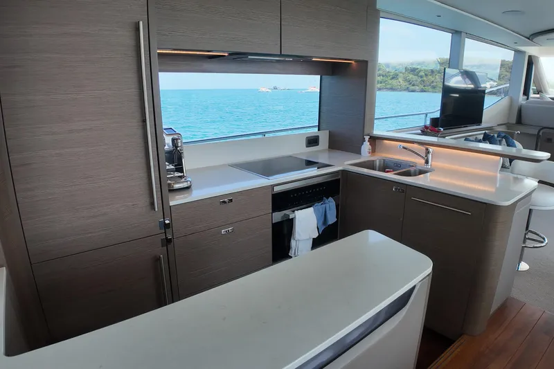La Mer Yacht Photos Pics Luxurious kitchen interior of 2023 Princess Y72 yacht with ocean view.