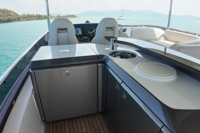 La Mer Yacht Photos Pics Luxurious 2023 Princess Y72 yacht interior with sleek kitchenette and ocean view.