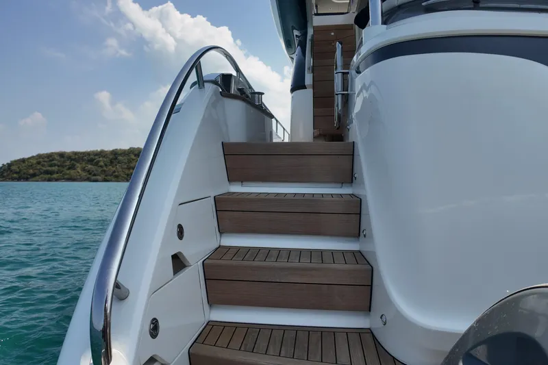 La Mer Yacht Photos Pics Staircase on 2023 Princess Y72 yacht with ocean view and clear sky.