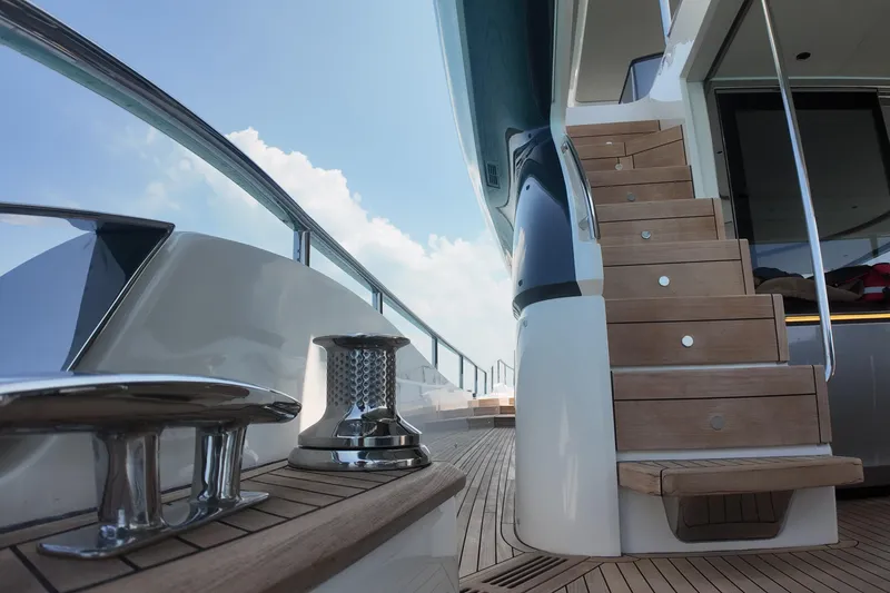 La Mer Yacht Photos Pics Luxurious 2023 Princess Y72 yacht deck with wooden stairs and sleek design.