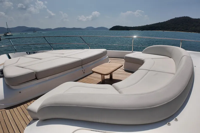 La Mer Yacht Photos Pics Luxurious seating area on 2023 Princess Y72 yacht, overlooking serene ocean and islands.
