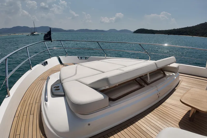 La Mer Yacht Photos Pics Luxurious 2023 Princess Y72 yacht deck with sunbed, overlooking serene ocean and distant islands.