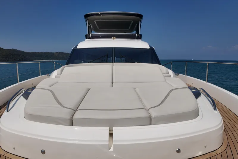 La Mer Yacht Photos Pics 2023 Princess Y72 yacht with spacious sunbed on deck, cruising in serene waters.